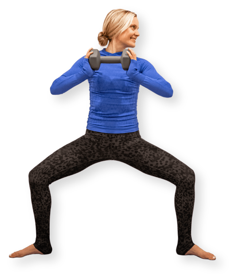 Katie is squatting with weights.